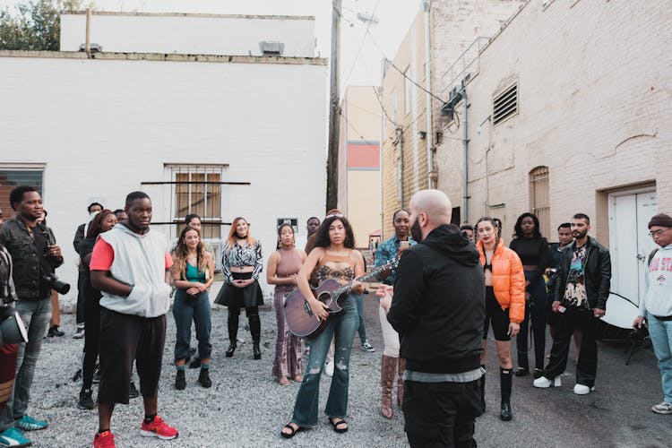 Group Of People Standing Outside Buildings