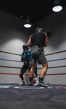 Two athletes in a boxing ring engaged in a fierce match, showcasing strength and agility.