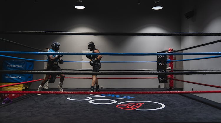 Two Men Fighting On The Ring