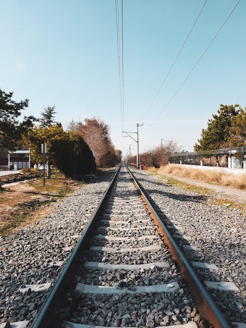 A Railroad on Gravel Under Power Lines
