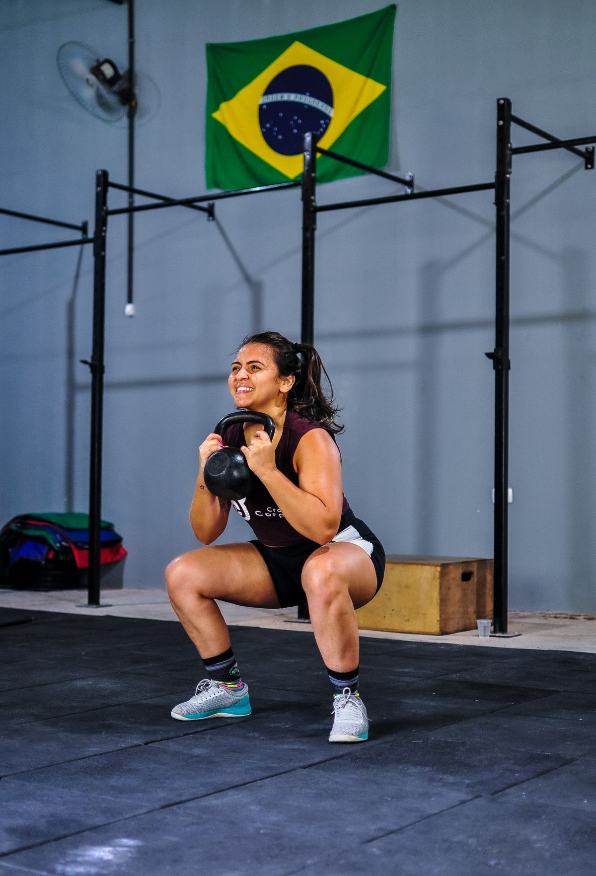 Woman performing kettlebell squats indoors