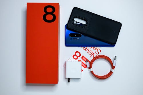 Blue Mobile Phone with Black Case on White Surface