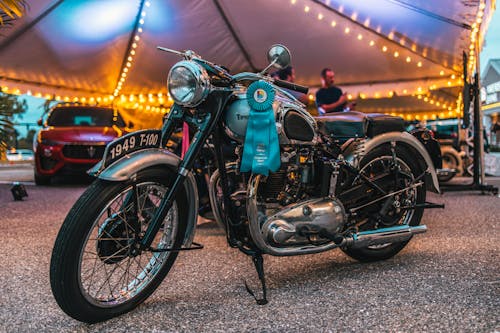 Blue Motorcycle Parked Beside a Tent