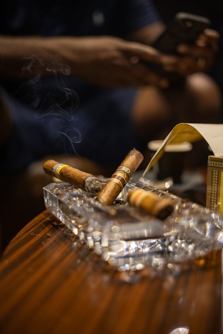 Burning Cigars On An Ashtray