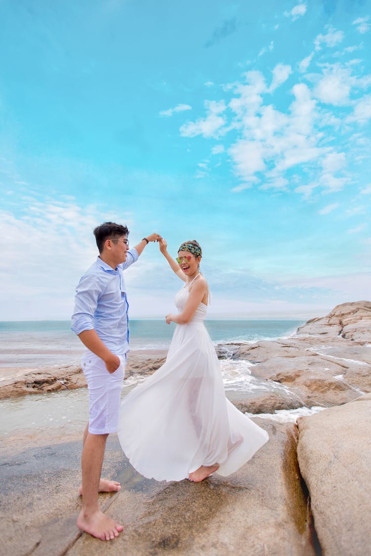 A Couple Dancing On The Beach