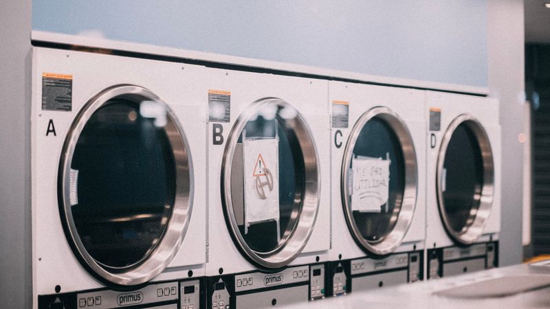 Front-loading laundry machines arranged in a laundromat
