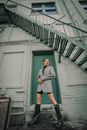 A Woman Posing at the Back of a Building