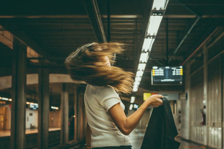Woman Tossing Her Hair At Subway Station