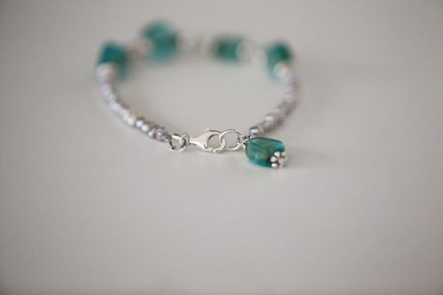 Free Close-up of a stylish beaded bracelet with turquoise stones and silver clasp. Stock Photo