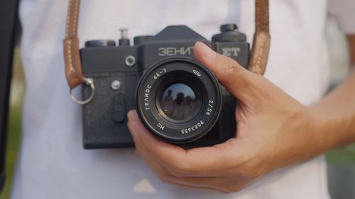 Free Close-up shot of a Zenit camera held by a person's hand outdoors in Indonesia. Stock Photo