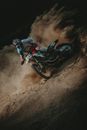 Man Riding Motocross Dirt Bike on Brown Sand