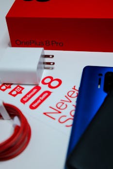 Close-up of OnePlus 8 Pro phone, charger, and packaging for an unboxing experience.