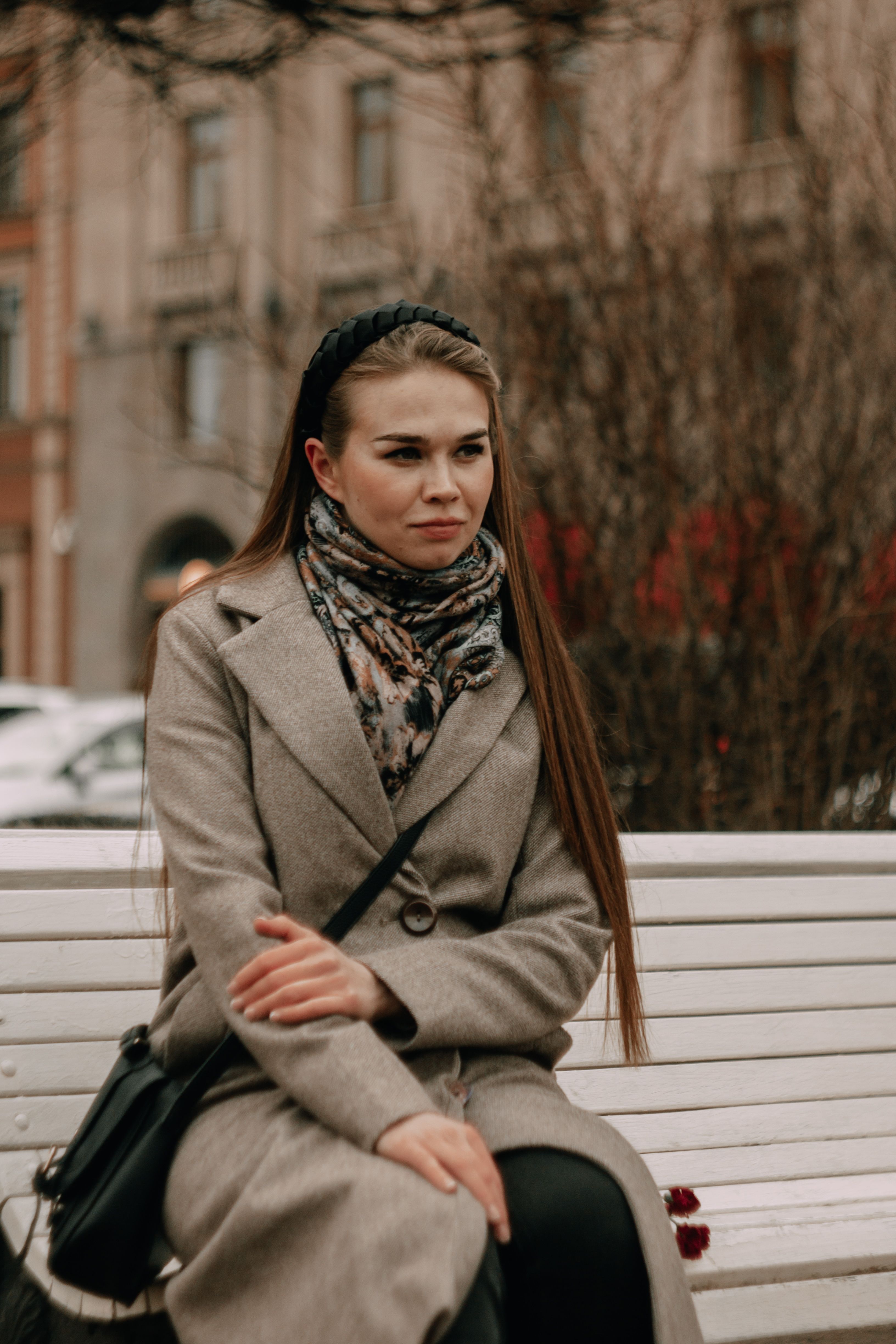 A Woman in Brown Coat Sitting on a Wooden Bench · Free Stock Photo