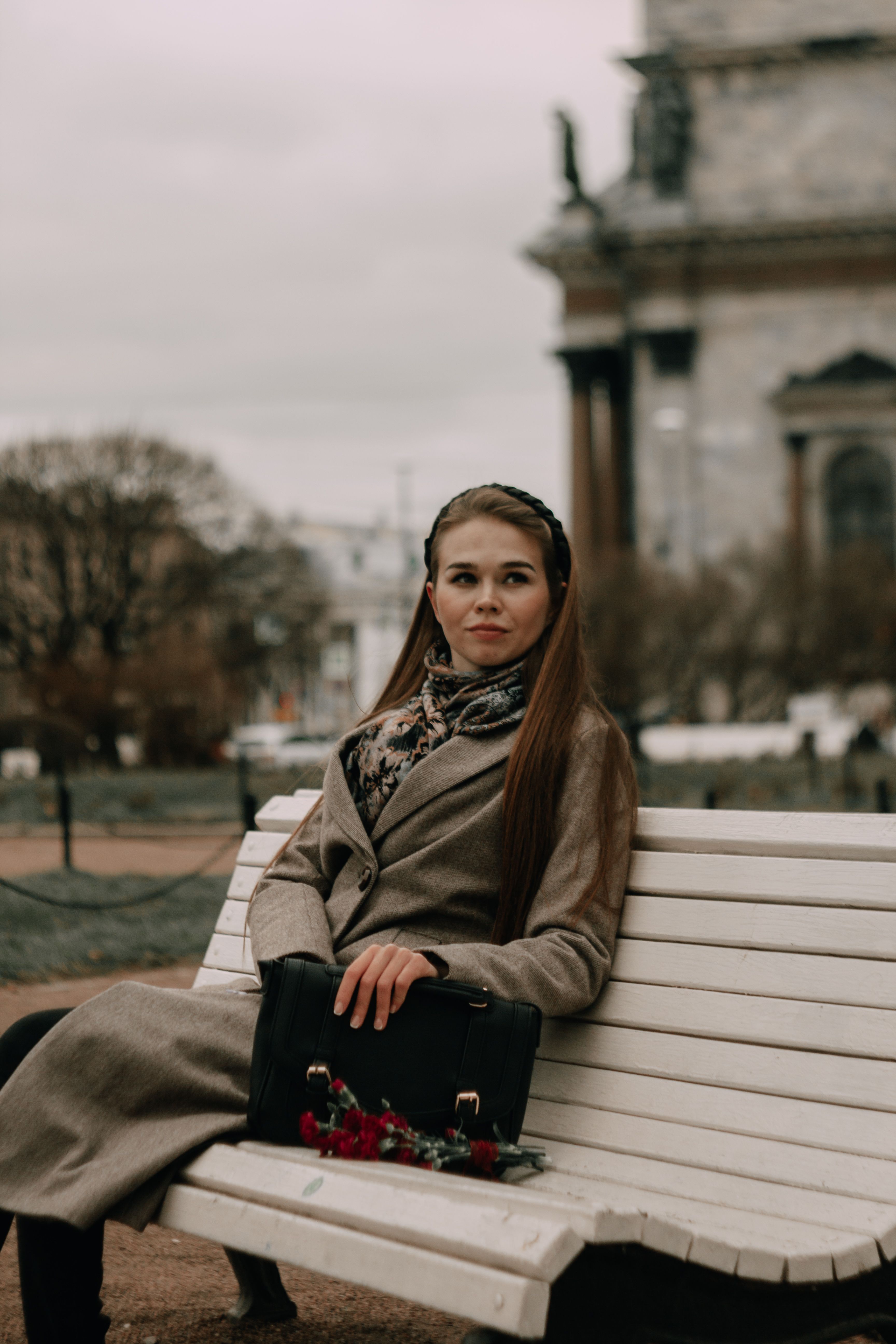 A Woman in Brown Coat Sitting on a Wooden Bench · Free Stock Photo