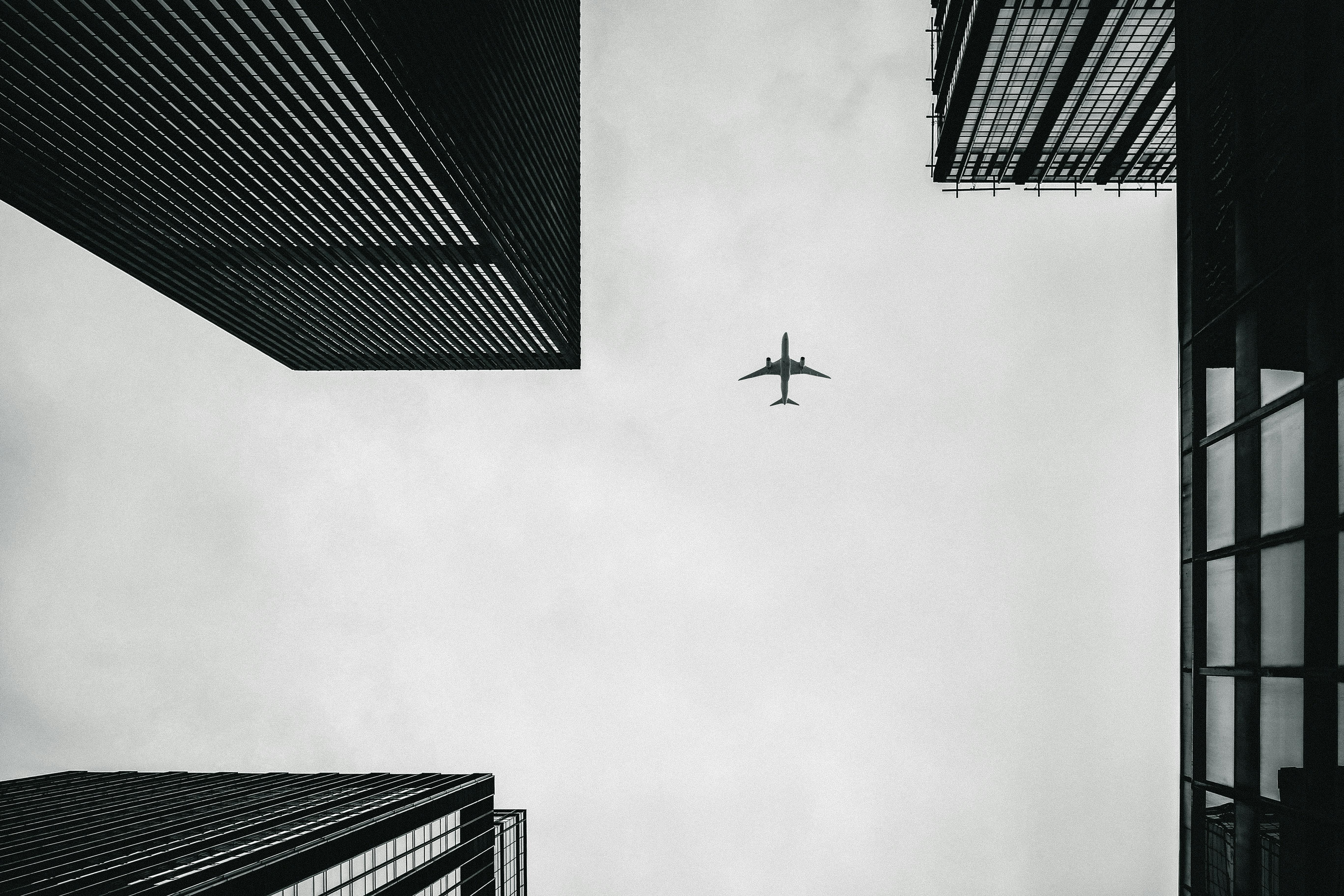 low angle photography of airplane and buildings