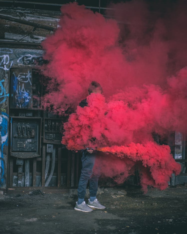 Photo Of Man Surrounded By Red Smoke