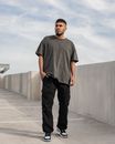 Young Bearded Man in Gray T-Shirt Standing with Hand in Pocket
