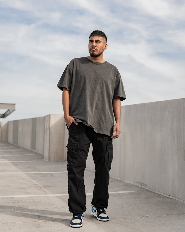 Young Bearded Man In Gray T-Shirt Standing With Hand In Pocket