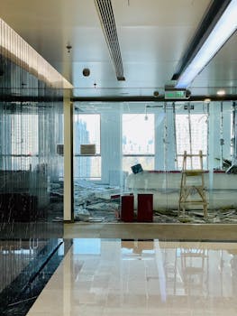 Bright and modern office in renovation with city skyline visible through large windows, ideal for construction themes.