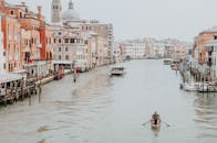 Man in White Shirt Riding on Boat on River
