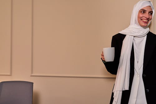 Muslim Office Worker in Hijab Drinking Coffee and Smiling