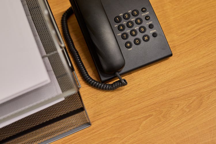 Telephone And Document Organizer Laying On Office Desk