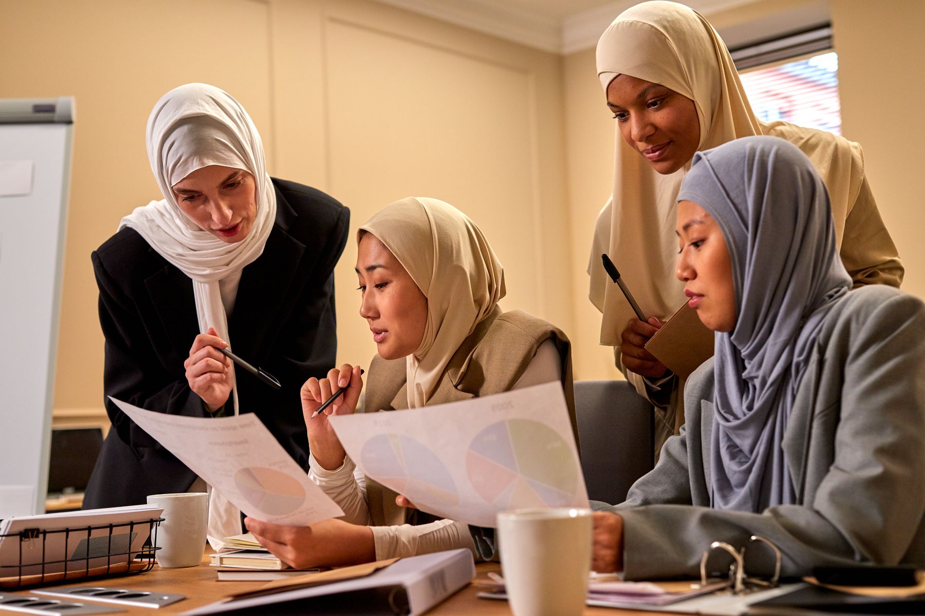 Muslim women discussing business strategy