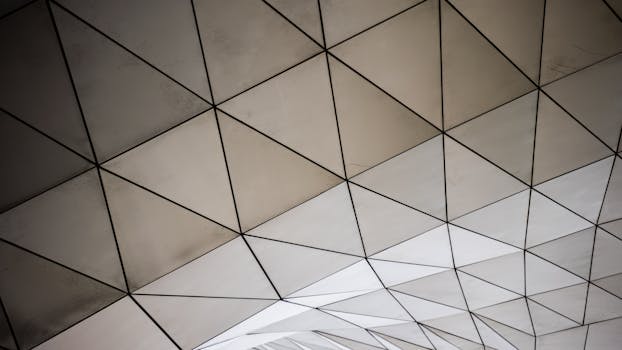 Abstract view of a modern geometric ceiling with triangular shapes and clean lines.