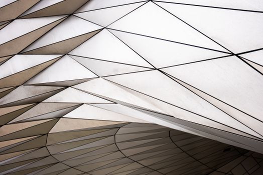 A striking minimalist geometric architectural detail featuring steel and light reflections in Lyon.