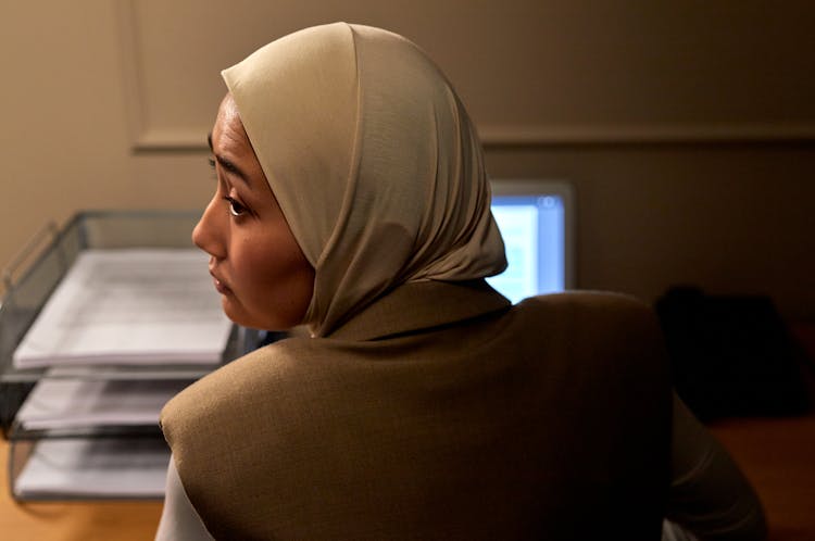 Woman In Hijab In Office Looking Over Shoulder