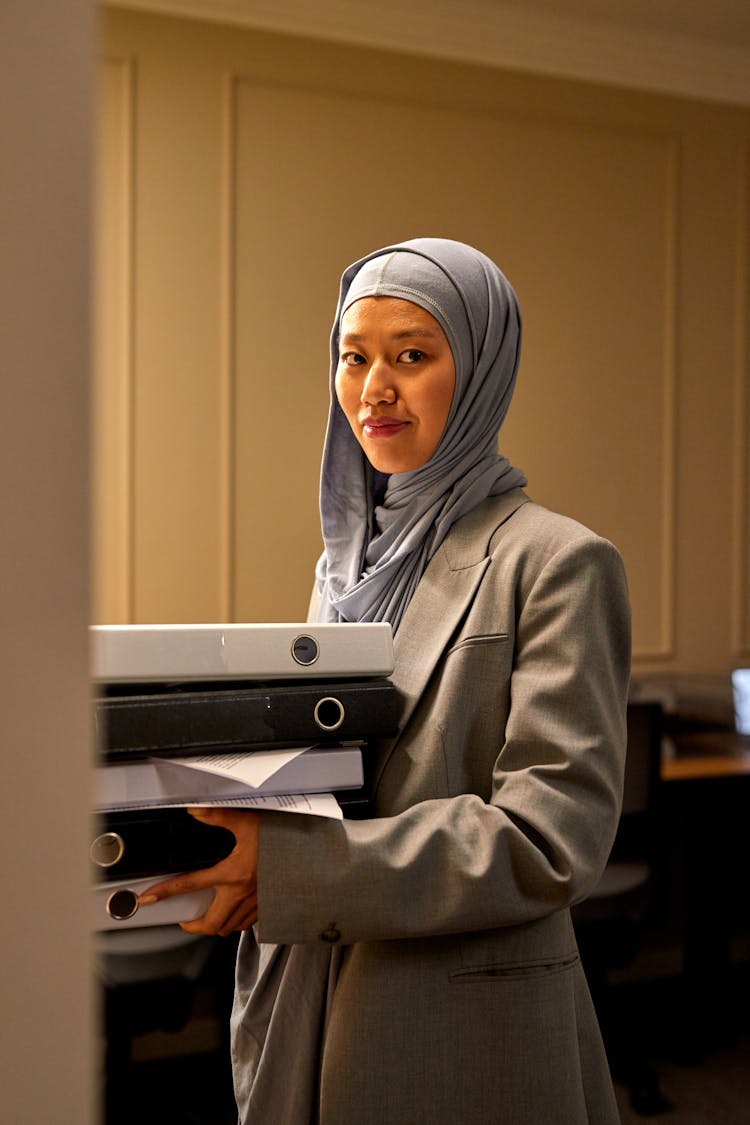 Woman In Hijab In Office Holding Binders