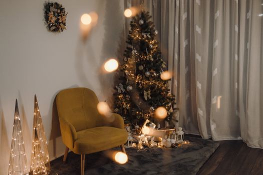Warm living room featuring a decorated Christmas tree and festive lighting.