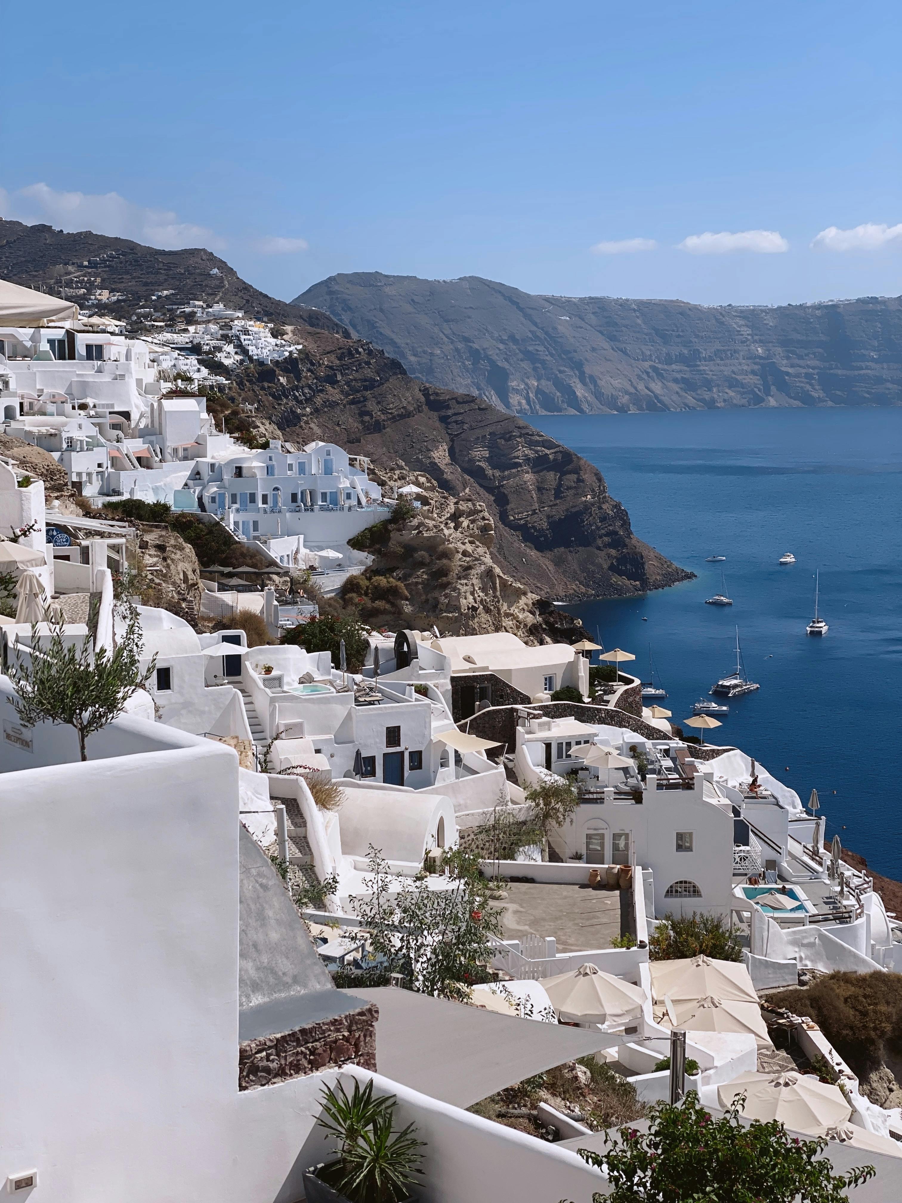 Breathtaking view of Santorini's iconic white buildings cascading down cliffs to the azure sea.