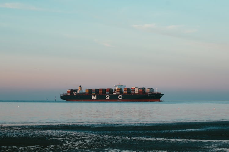 Cargo Ship Cruising On Sea