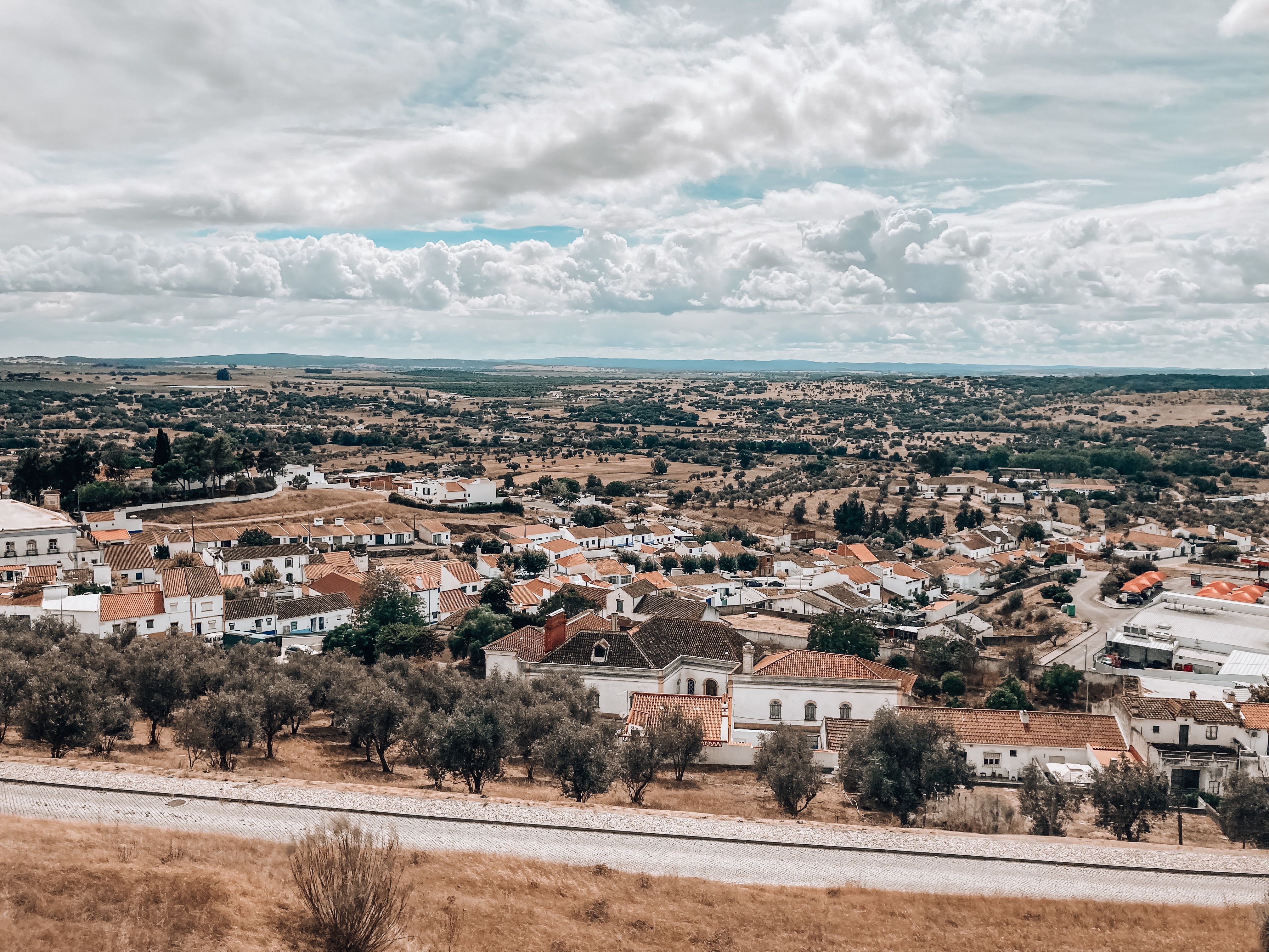 A picturesque aerial view of a village in Portugal with rolling hills and scenic landscapes.