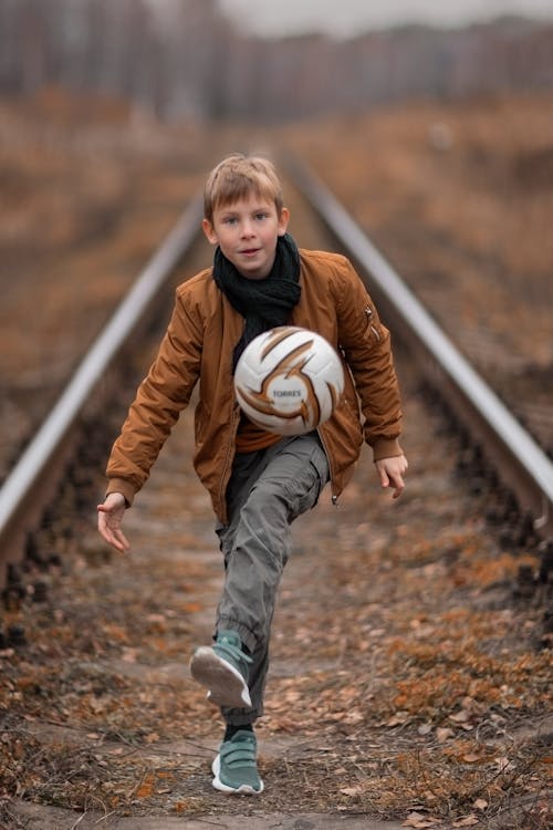 Free Kid Playing with a Soccer Ball Stock Photo