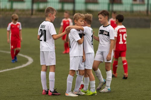 Free Boys on the Soccer Field Wearing White Uniforms Stock Photo