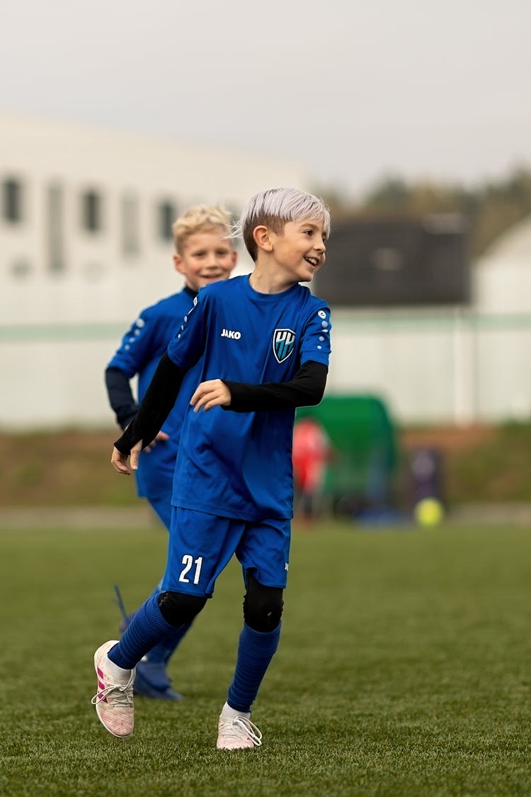 Young Boys In Blue Uniforms Playing Soccer