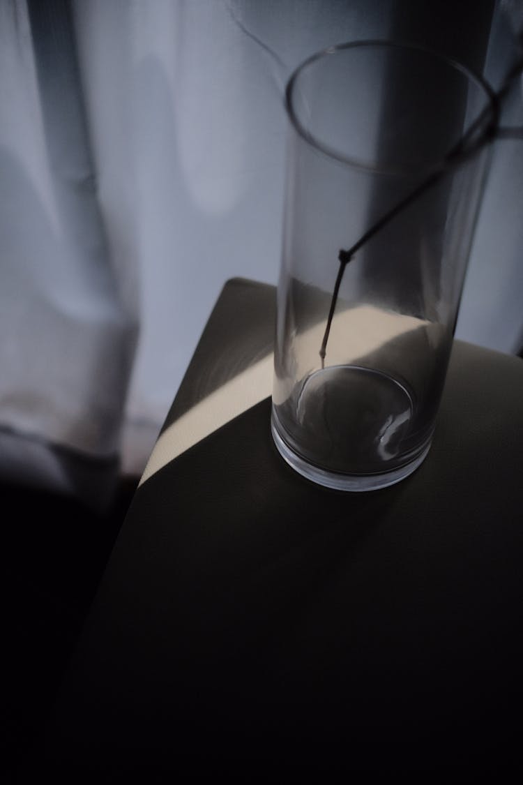 Clear Drinking Glass On The Edge Of A Table