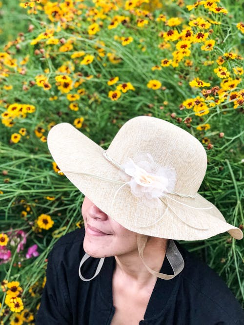 Close-Up Photography of a Woman Near Flowers