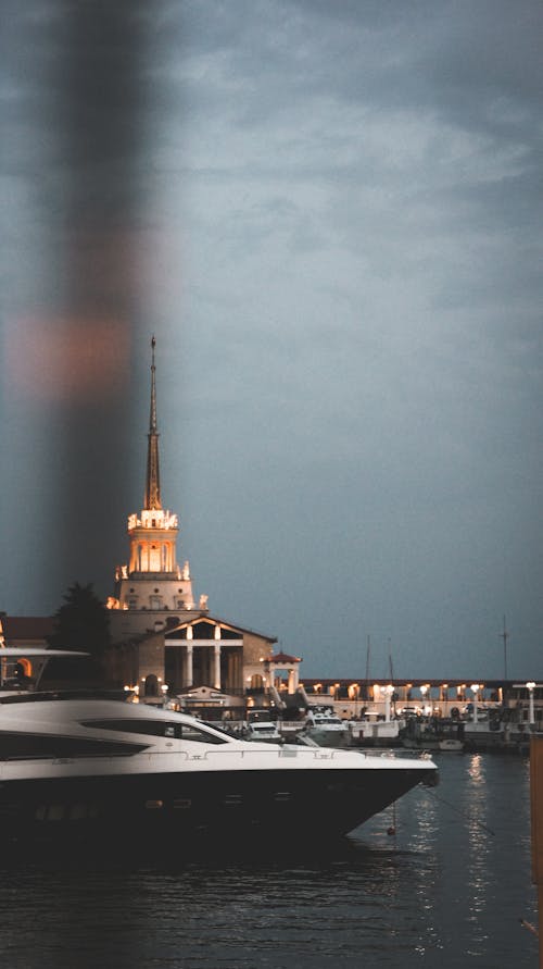 Clouds over Tower in Town and Motor Yacht