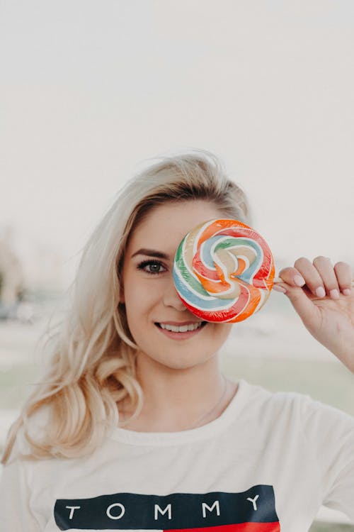 Free Close-Up Photography of a Woman Holding Lollipop Stock Photo