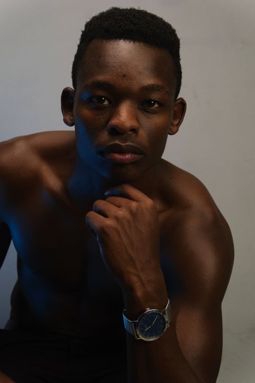 Free Close-up portrait of a shirtless man wearing a wristwatch, posing thoughtfully. Stock Photo