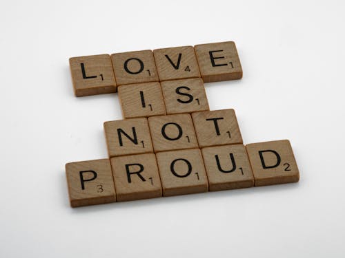 Wooden Scrabble Pieces on White Surface