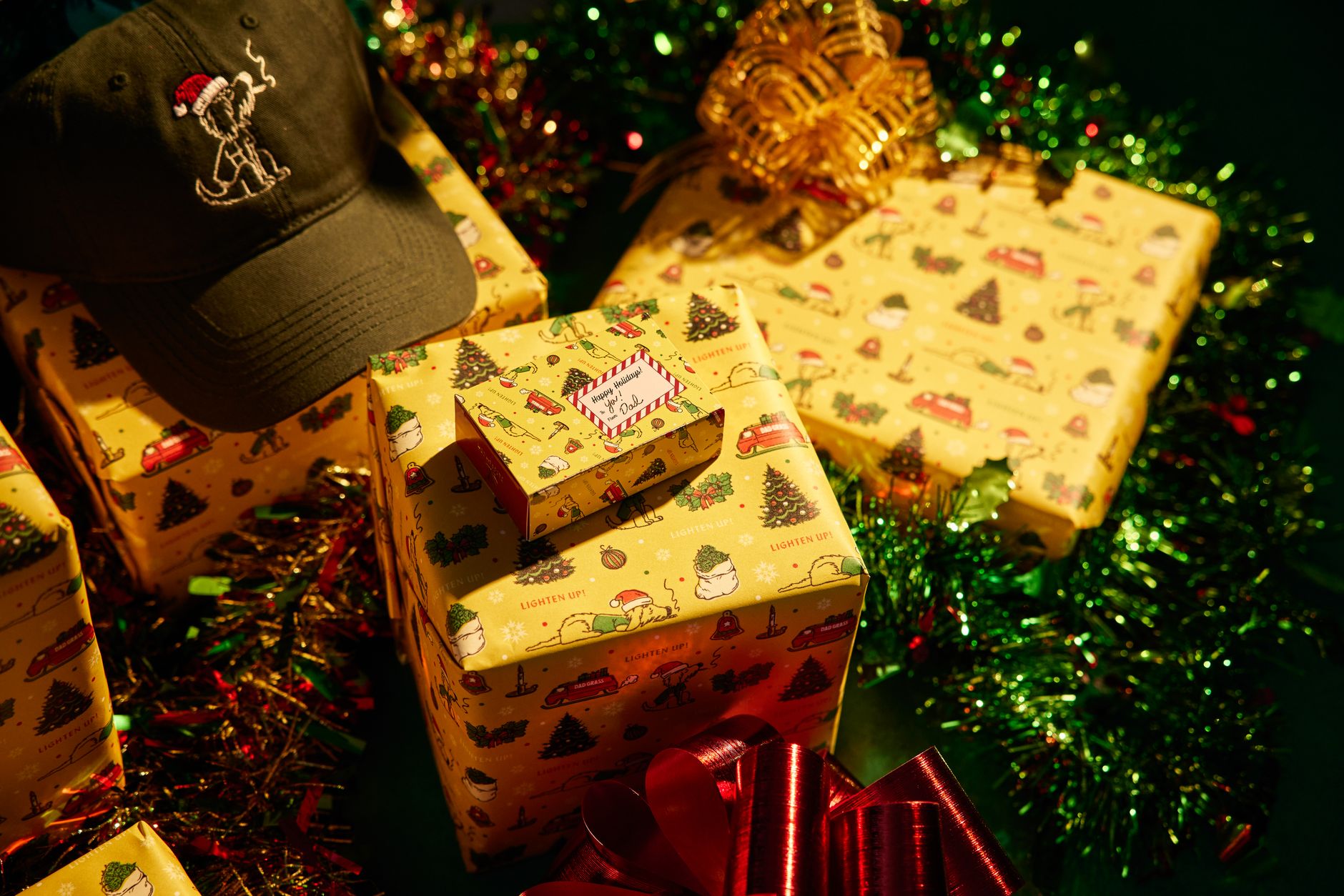 A close-up of Christmas gifts wrapped in festive paper, adorned with a Santa hat.