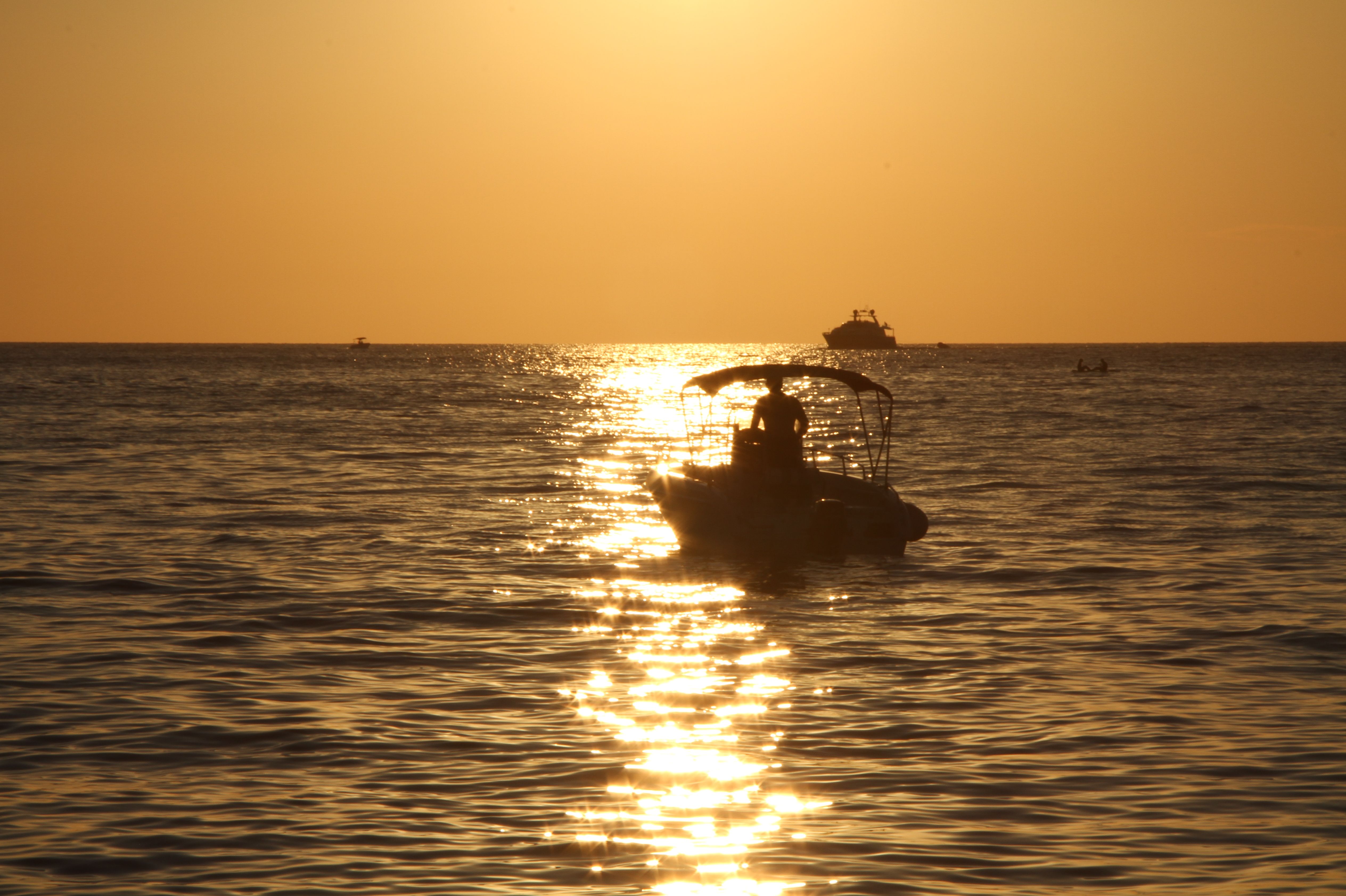 Silhouette of Motorboat on Body of Water · Free Stock Photo