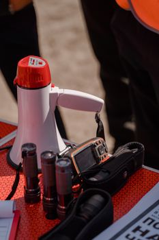 Close-up of a megaphone and flashlights on a table, ideal for teamwork settings.