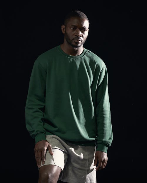 Man in Green Sweater Looking Afar