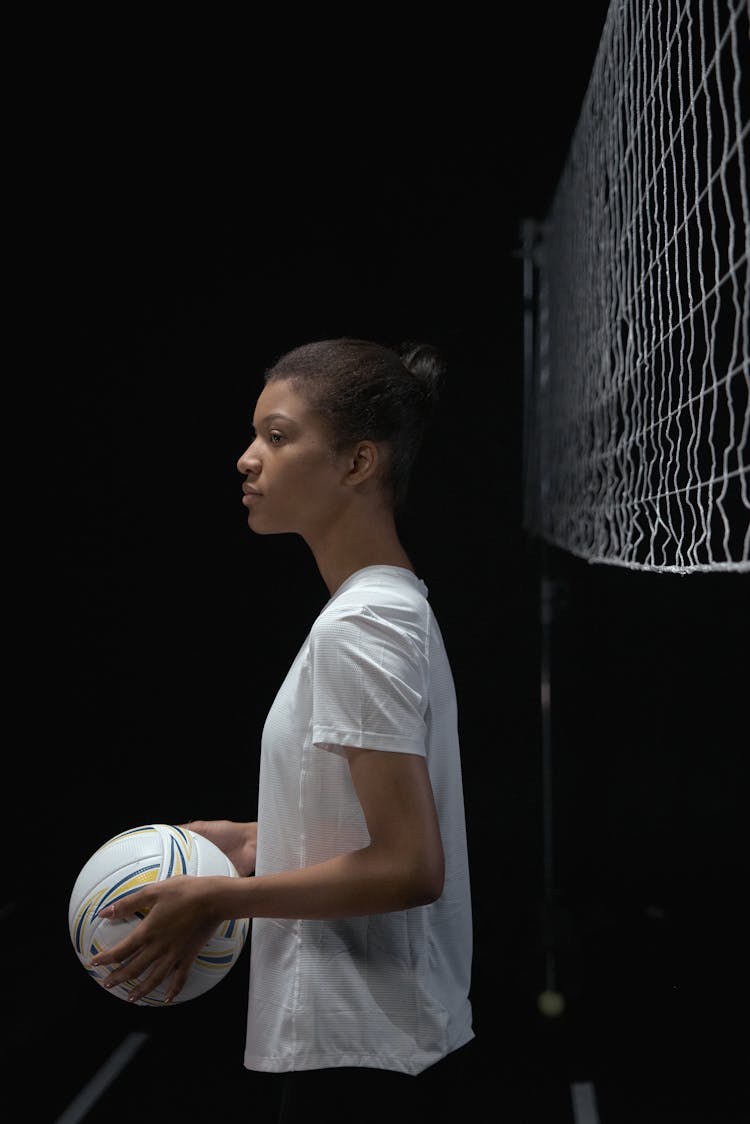 A Woman Holding A Volleyball