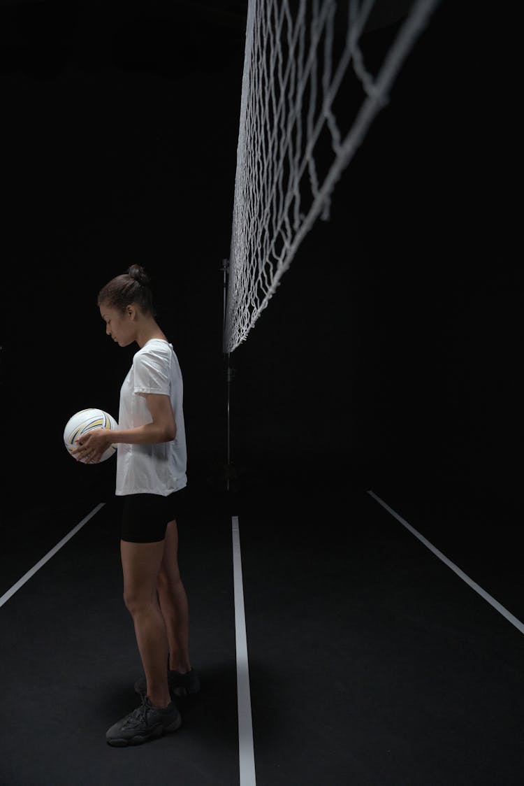 A Woman Holding A Volleyball